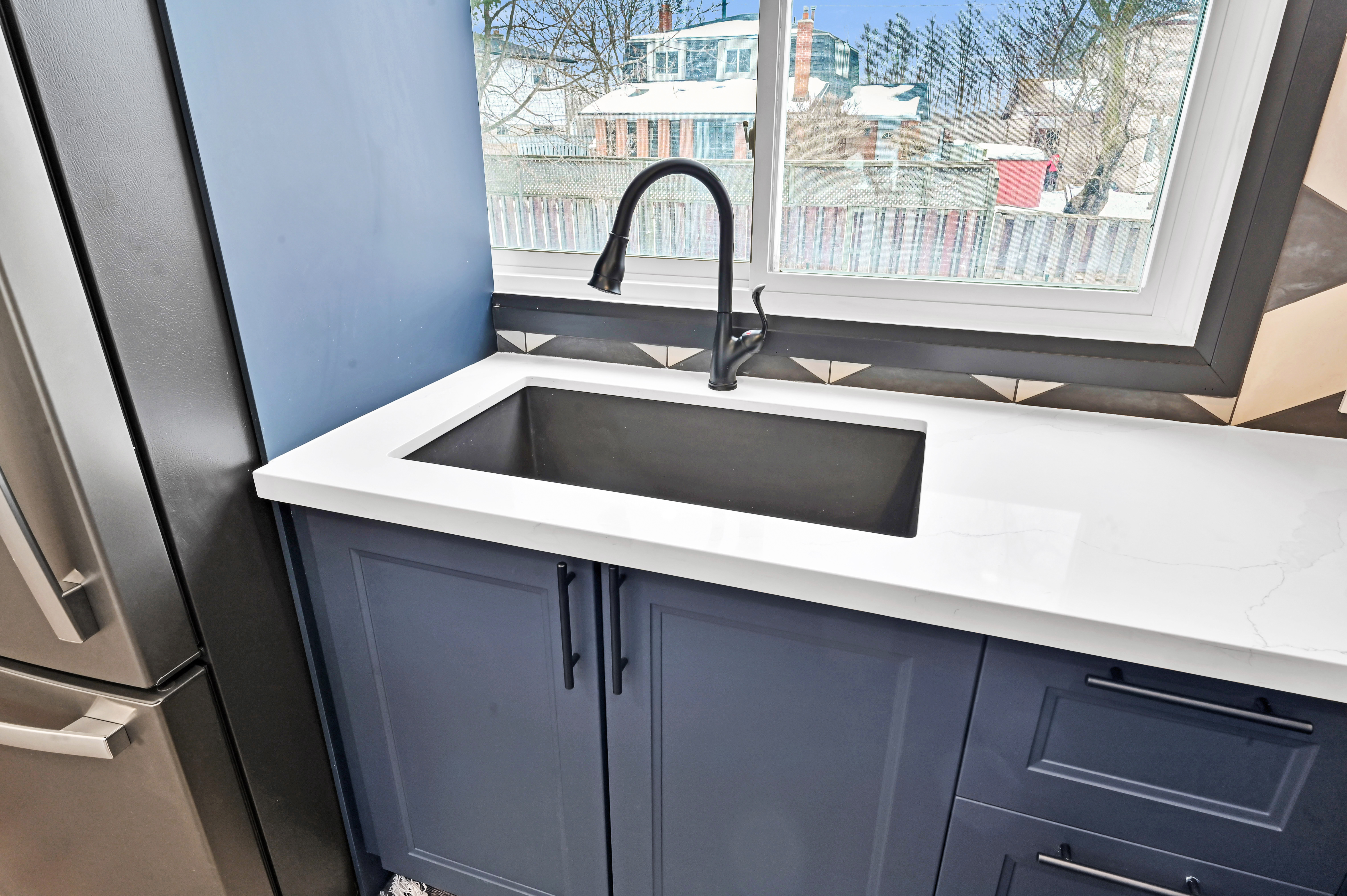 Bright finished kitchen with premium quartz countertops and modern black fixtures — excellent portfolio shot — Kron, Hamilton | MTC Renovations
